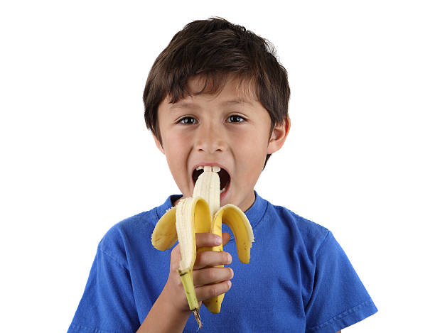istock Young boy eating banana 135512288