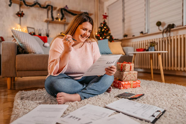 istock Young woman paying bills at Christmas 1355123579