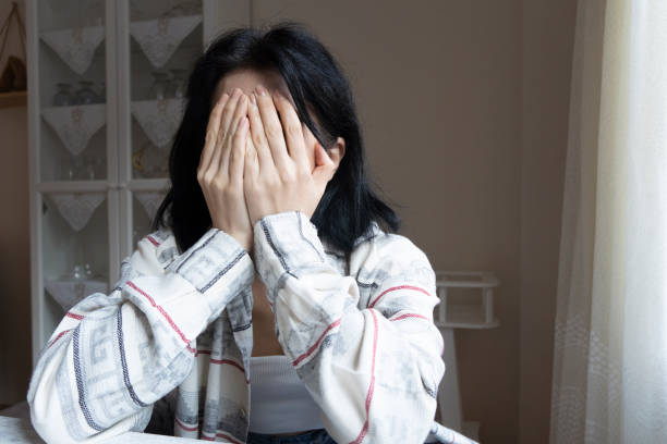 istock Young girl covering her face with her hands 1355124292