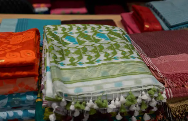 Retail display of vibrant coloured Indian sarees inside a shop at Phulia, near Santipur, West Bengal. Both Phulia and Santipur are famous for handloom sarees (sari, textile usually worn by Indian women) since ancient times.