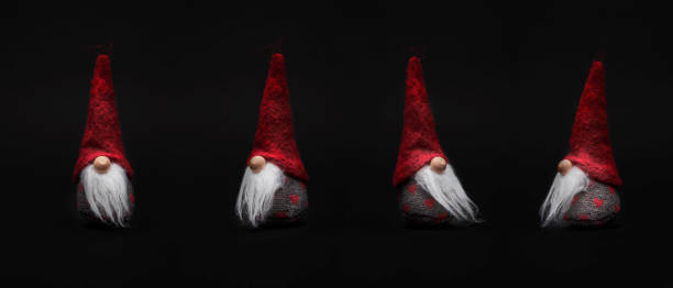 Little Santa Claus with red cap isolated against a dark background Little Santa Claus with red cap isolated against a dark background mütze stock pictures, royalty-free photos & images