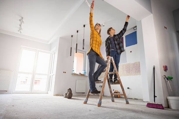 mother and son painting wall at home - repairing apartment home improvement painting imagens e fotografias de stock