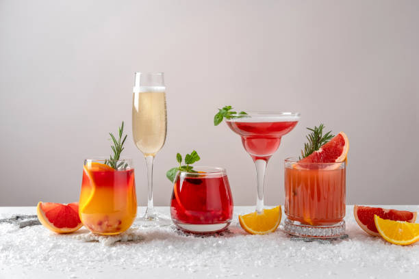 festive cocktails with various citrus. assortment of alcohol christmas drinks. pink and red sangria cocktails, champagne, pomegranate  jingle and citrus tequila smash. - kokteyl stok fotoğraflar ve resimler