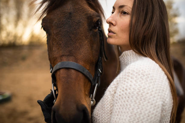 istock A female equestrian hugging her horse 1355127561