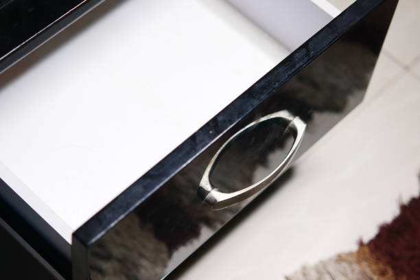 istock man's hand open drawer wooden in cabinet 1355128954