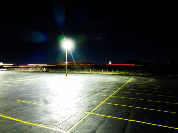 istock Night parking lot with traffic blur in back 1355129976
