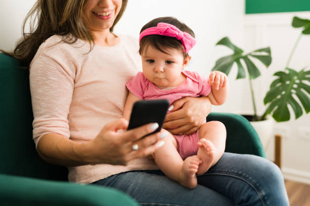 istock Happy mother with her baby on her lap 1355130669