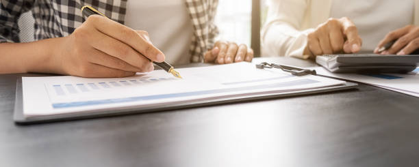 istock Business team brainstorming and discussing with financial data and report graph. Teamwork meeting working concept. 1355130765