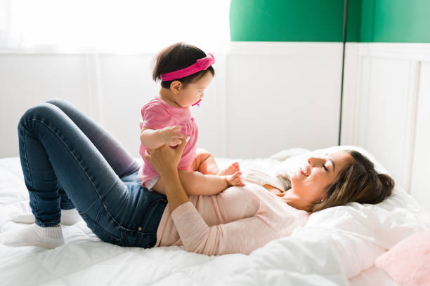 istock Mother playing with her adorable baby 1355131446