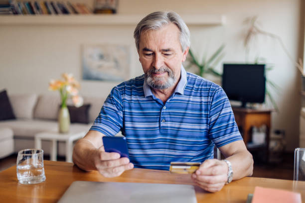 istock Senior purchasing some items on the internet 1355131596