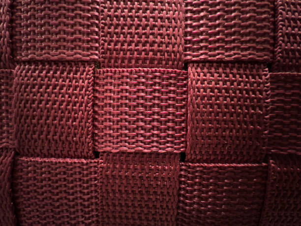 A braided, pink fabric as texture or background.