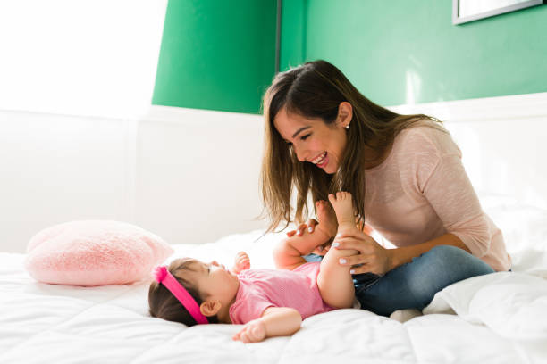 istock Cheerful mother making her baby laugh 1355131721
