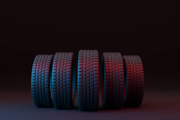 istock Five car tires stacked on a black background 1355133153