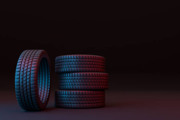 istock Four car tires stacked on a black background 1355133195