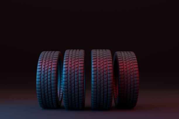 istock Four car tires stacked on a black background 1355133247