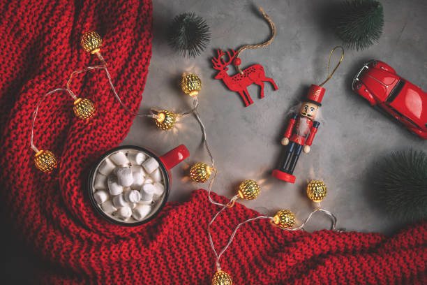 istock mug with drink marshmallow, garlands, red blanket on a gray background 1355135502