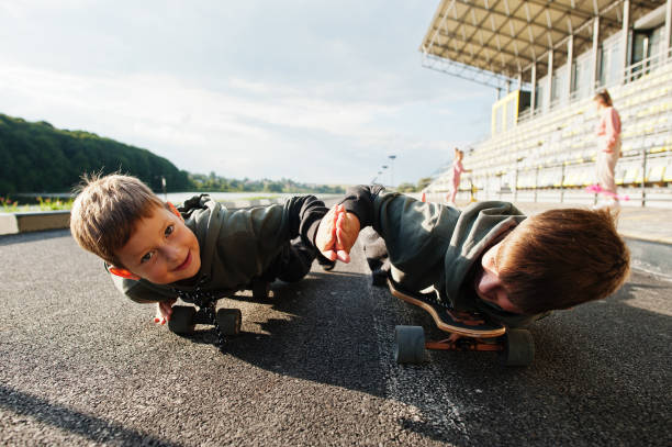 istock Two boys in skates. Brother's love. 1355137822