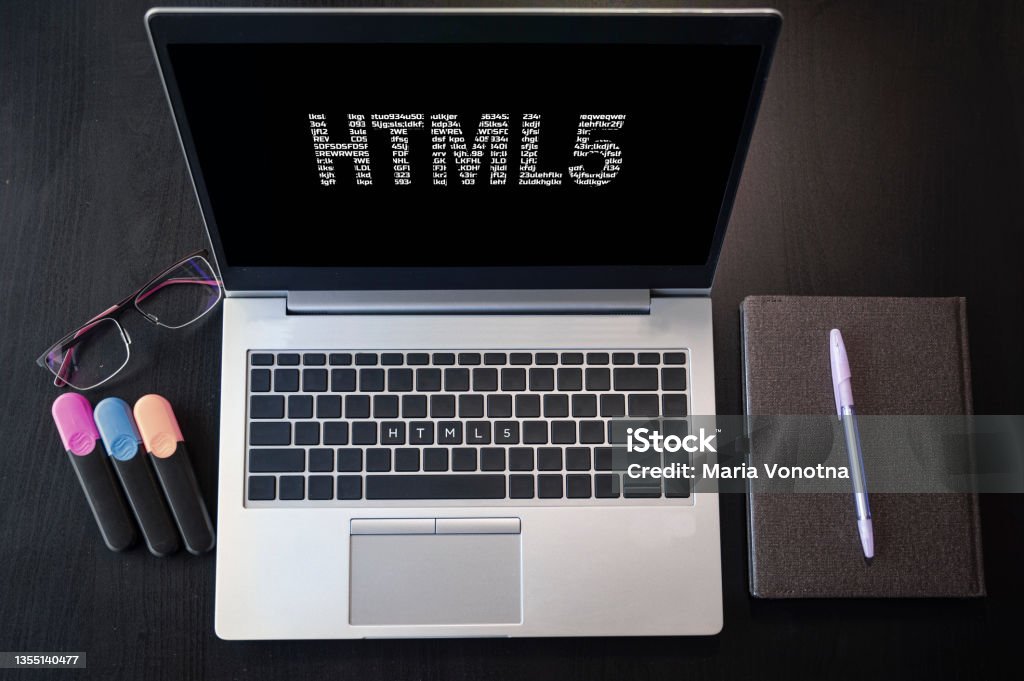 Top view of laptop with text HTML5. Html5 inscription on laptop screen and keyboard. Learn html language, computer courses, training. Above Stock Photo