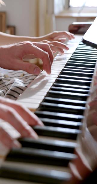 istock vertical photo of a piano four hands 1355141891