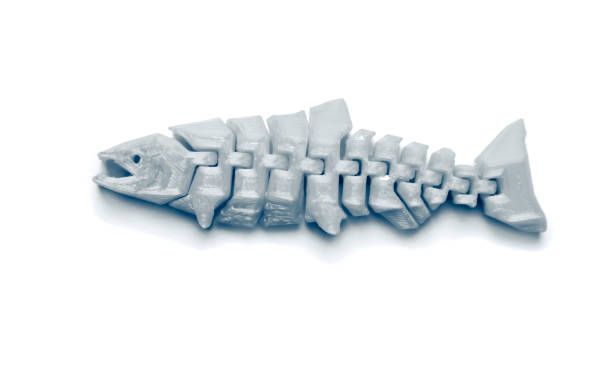 istock Bright light yellow object in shape of fish toy printed on 3d printer 1355143419