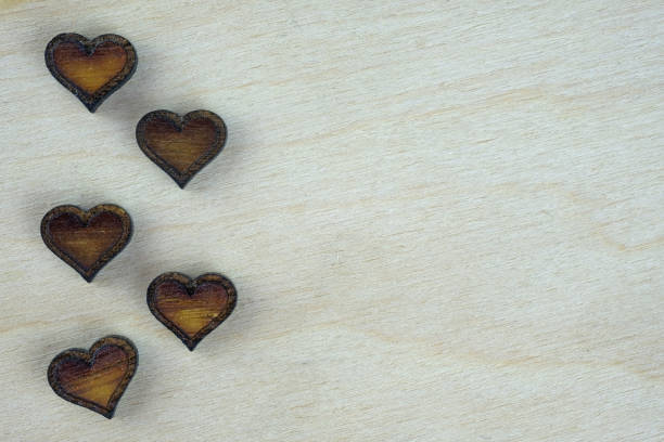 istock Small brown wooden hearts top view. 1355143684