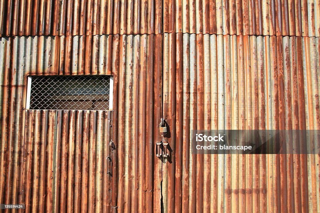 Background: rusty grunge door with master key lock Background: rusty grunge zinc door with master key lock Abandoned Stock Photo