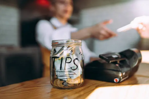 The woman pays for the food with a card