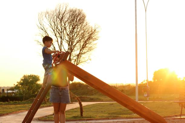 mother with child on the playground slide