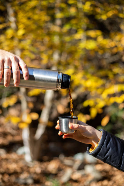 istock Pouring coffee from thermos in cup 1355148006