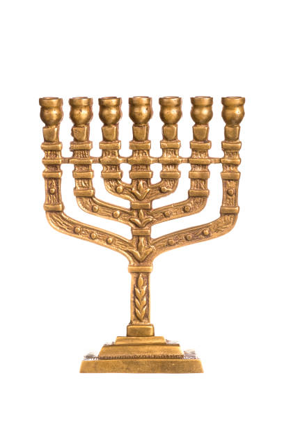 istock Hanukkah candlestick isolated on white. Ritual candle menorah on a white background. Menorah is the symbol of Judaism. 1355148136