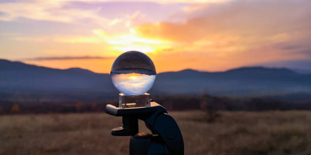 Autumn landscape at sunset in the mountains through a crystal ball stock photo