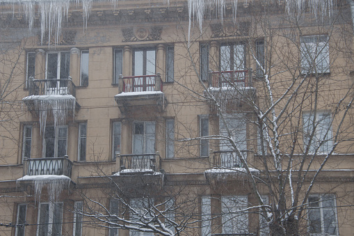 giant icicles hanging from the eaves and balconies of the house