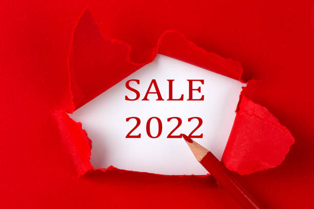 istock SALE 2022 text on the red torn paper with red pencil 1355150479