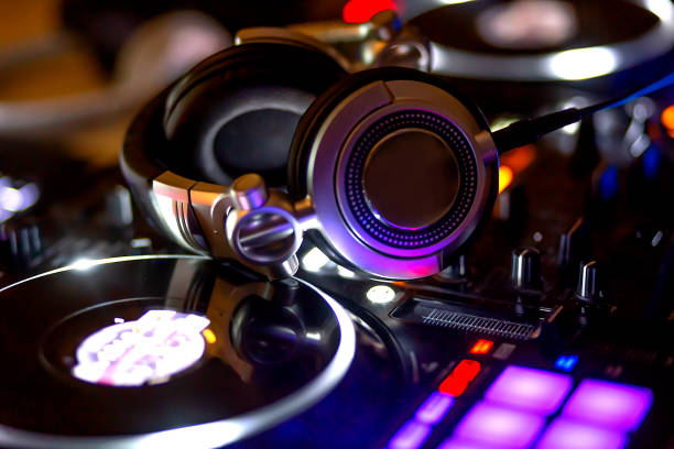 istock DJ remote control and headphones. Digital multimedia composition gadget, mixing console electronic device 1355150498