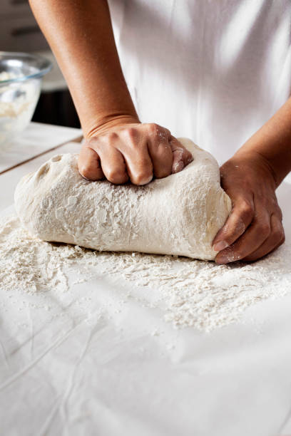 istock Making yeast dough, Hands knead dough, Kneading dough 1355151993