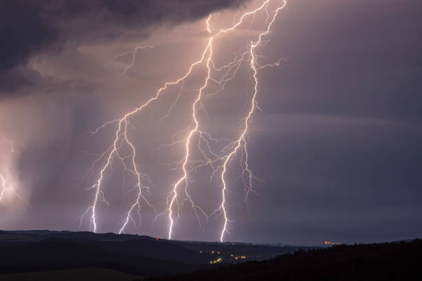 istock Huge lightnings at night with landscape 1355153185