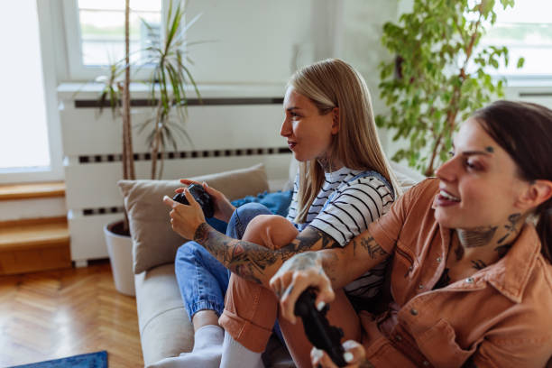 istock Lesbian couple playing video games at home 1355153503