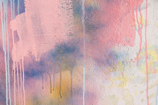 Abstract pastel pink, blue, white painter plastered wall background with colorful drips, flows, streaks of paint and paint sprays