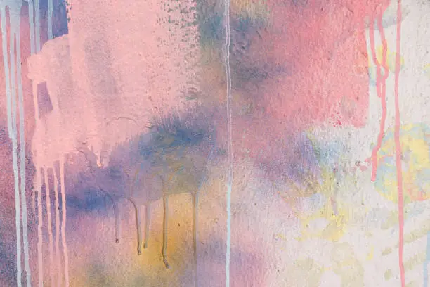 Abstract pastel pink, blue, white painter plastered wall background with colorful drips, flows, streaks of paint and paint sprays.