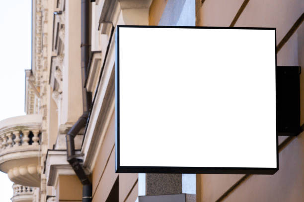 istock Mock up. Blank white rectangular shape signboard on the wall outdoors. Signage of shop, store, cafe, restaurant 1355156911