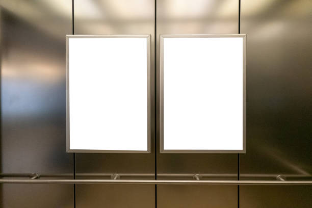 Mock up. Two vertical poster media template frame hanging on the wall in elevator lift