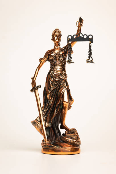 istock Justilia or Themis (Symbol of Justice) statue isolated on white background with clipping path 1355158823