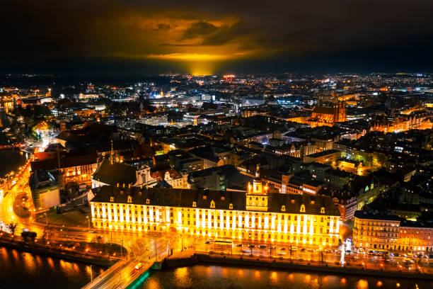 night panorama of the old european city of wroclaw from above. a beautiful old town illuminated by bright lights. aerial photography. wroclaw, poland - wroclaw traffic night flowing imagens e fotografias de stock