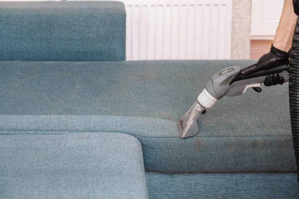 istock Men use a vacuum cleaner to clean the sofa 1355162674