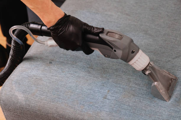 istock Men use a vacuum cleaner to clean the sofa 1355162702