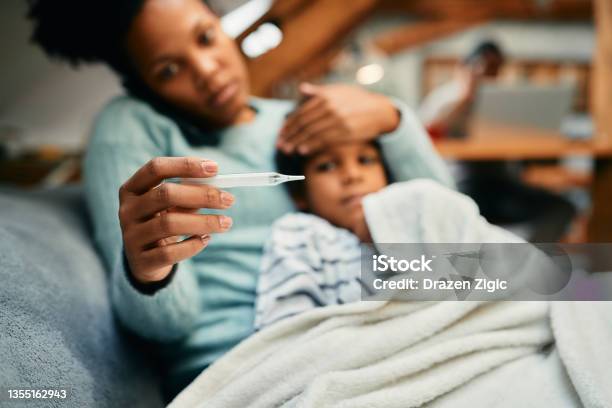 Closeup Of Black Mother Measuring Sick Sons Temperature Stock Photo - Download Image Now