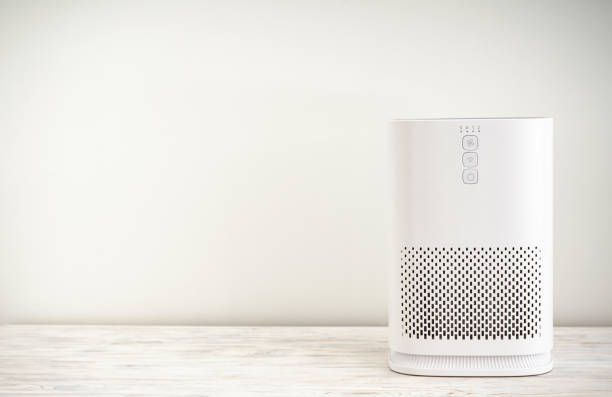 istock Air purifier with ionization in the room on a light background, space for text. 1355163624