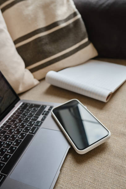 istock Modern computer gadgets: laptop and smartphone close-up. Remote work. Work from home. Business background. Office at home 1355163761