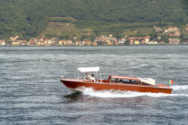 Lake Como, Italy - June 2019: Private motor launch taking passengers to their hotel on Lake Como.