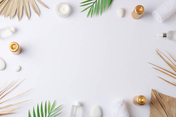 istock Spa treatment with cosmetic bottle, candles and palm leaf on white background. Flat lay, copy space 1355168565
